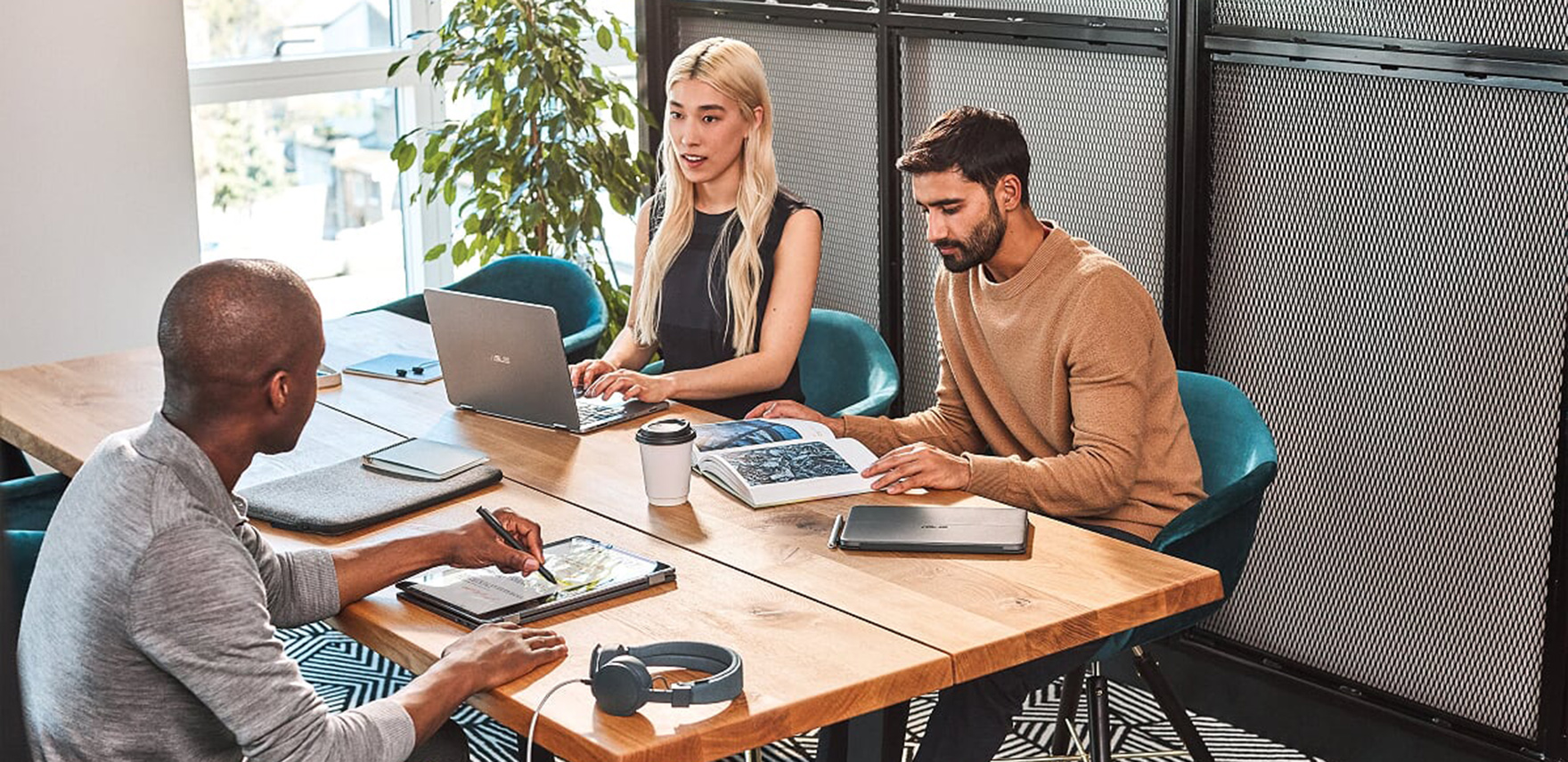 Three people working together on mobile devices