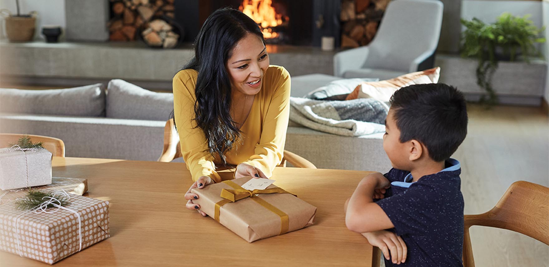 Mother giving her son a wrapped present