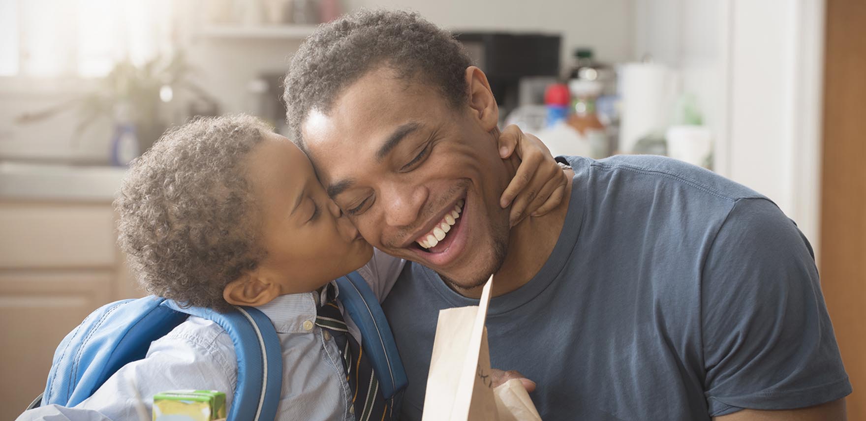 Son kissing his happy father