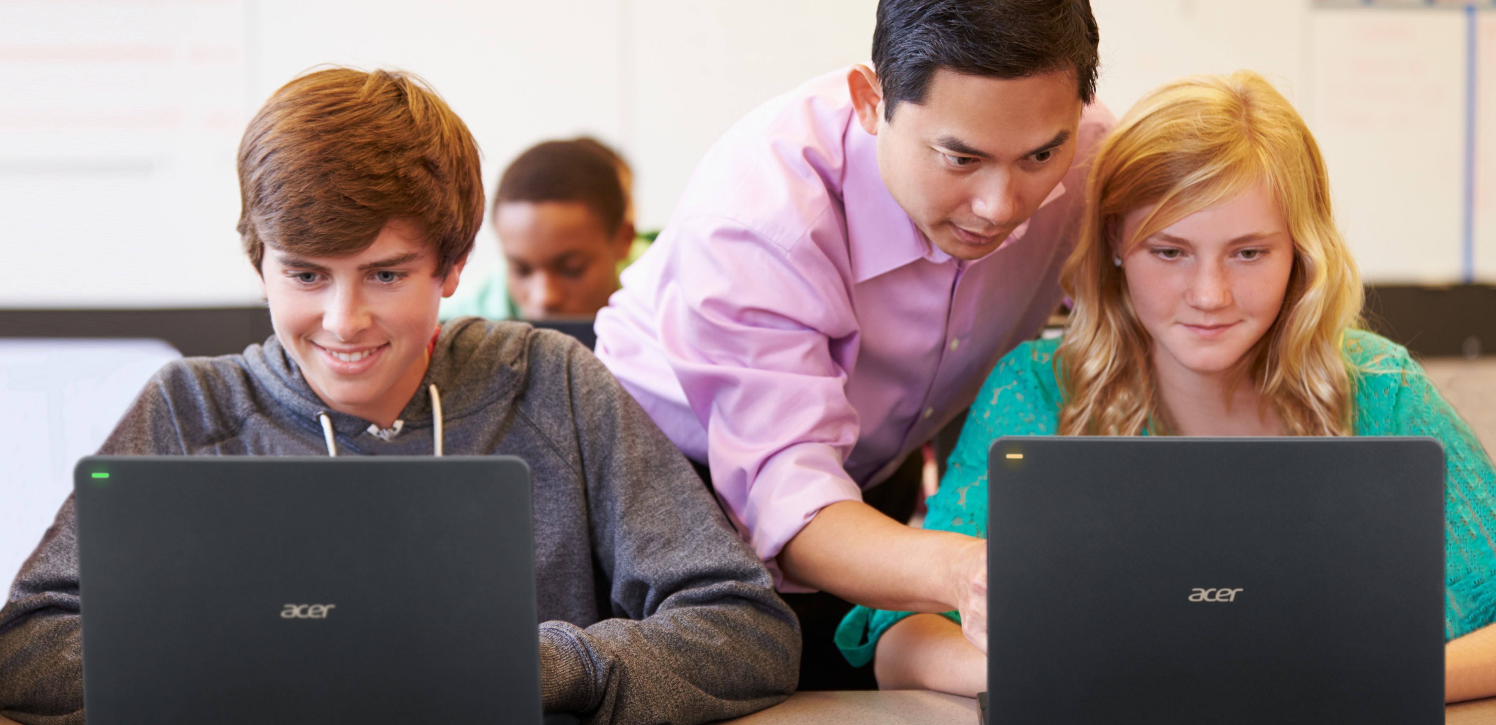 The Acer TravelMate B117 with Windows 10 Pro in the classroom, the orange light means that the student raised her hand for assistance.