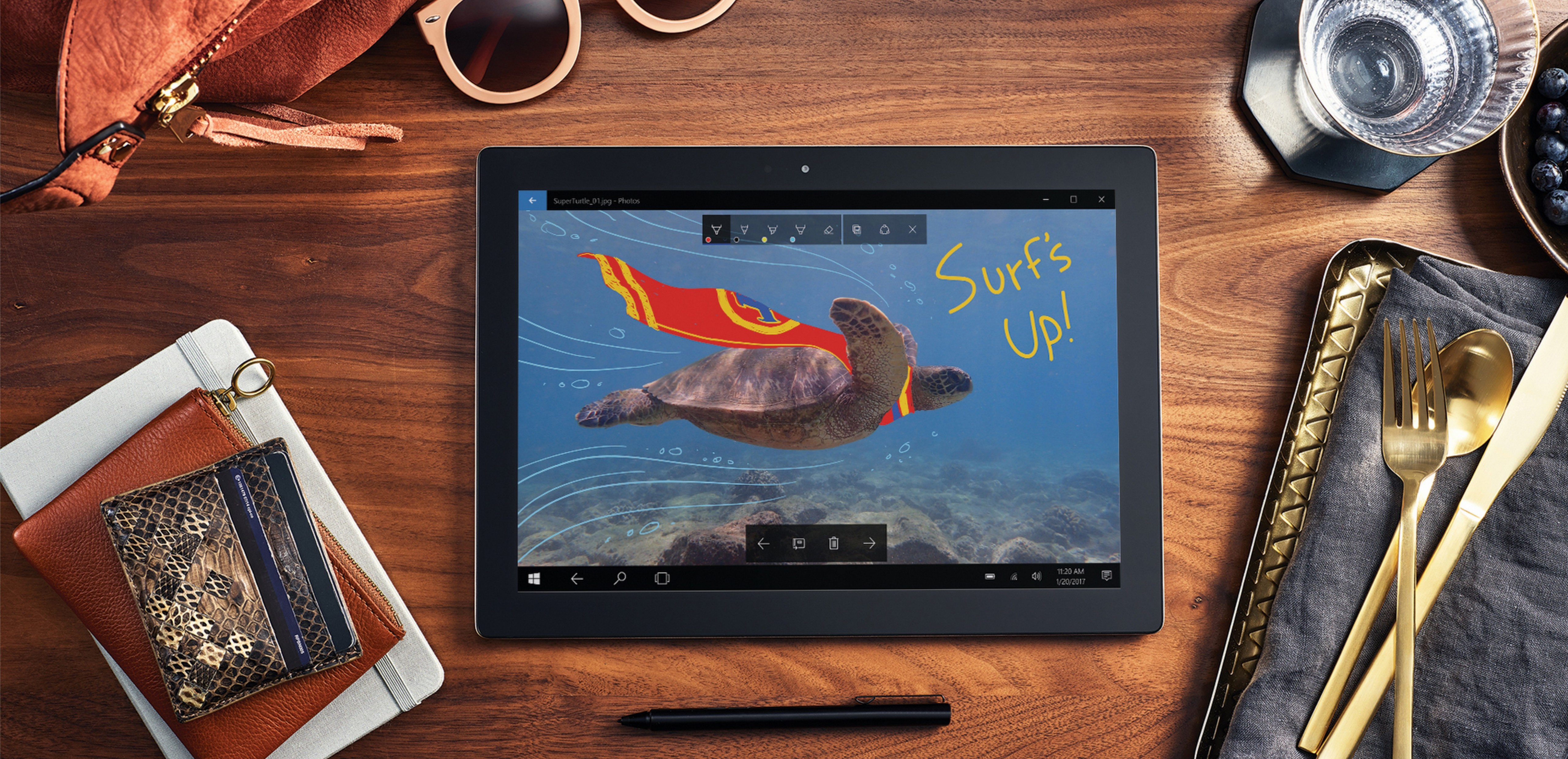 Windows 10 tablet on a desk with Windows Ink in the Photos app.