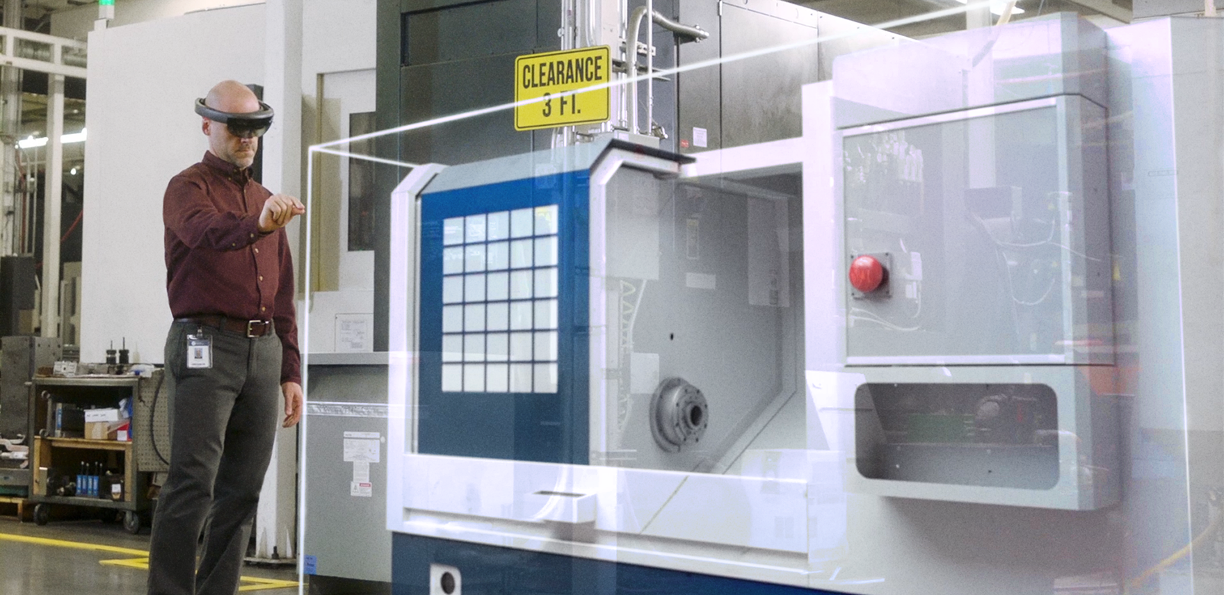 Man standing in a factory wearing Microsoft HoloLens.
