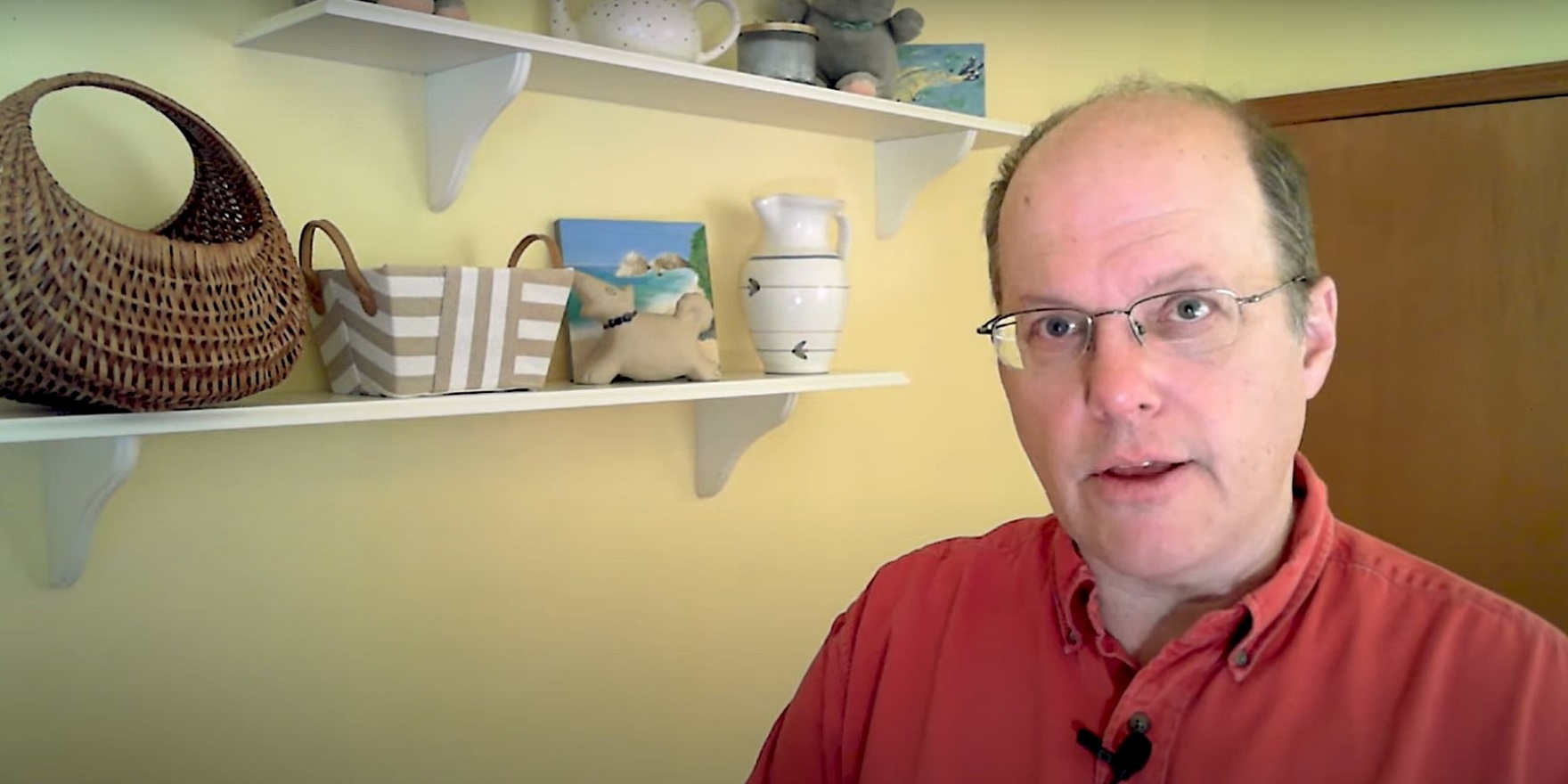 Doug Thomas standing in a room next to a shelf