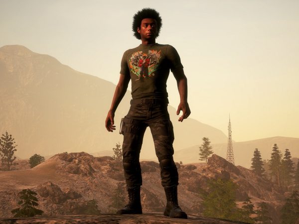 Black man wearing the new T-shirt with a desert in the background