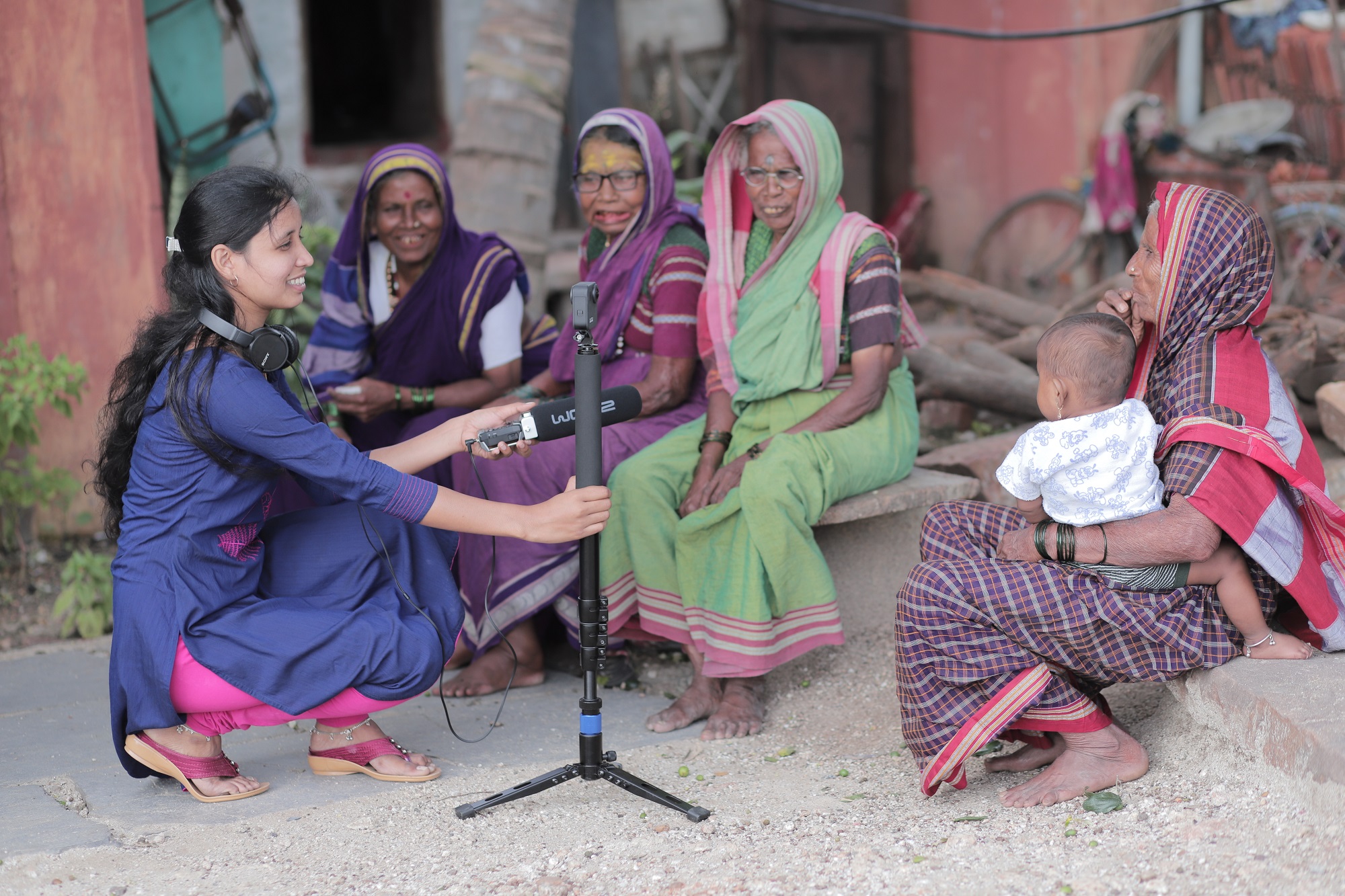 Women sitting around camera