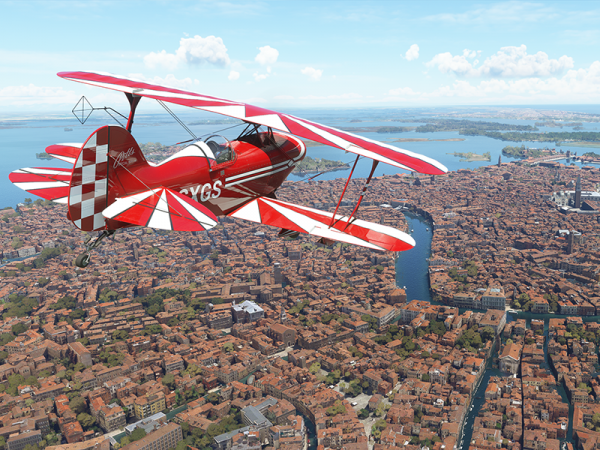 Biplane flying over a city