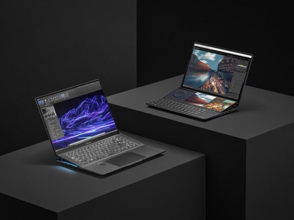 Two laptops set on tables one above the other