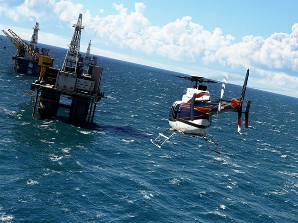 Helicopter approaches an oil rig out at sea