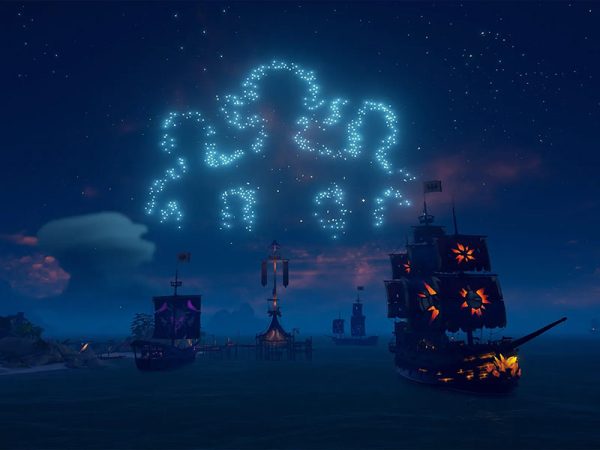 Fireworks above pirate ships form the outline of Sea of Thieves characters