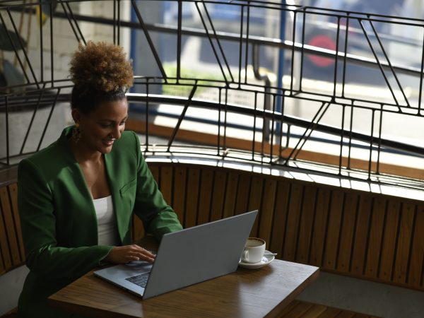 Woman sitting at a table working on a laptop