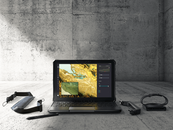 Dell Rugged Tablet with accessories open and on a concrete platform