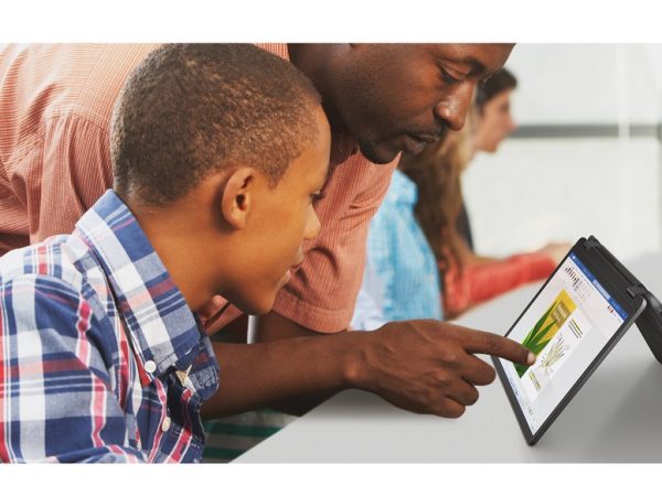 Teacher and student working side by side with tablet