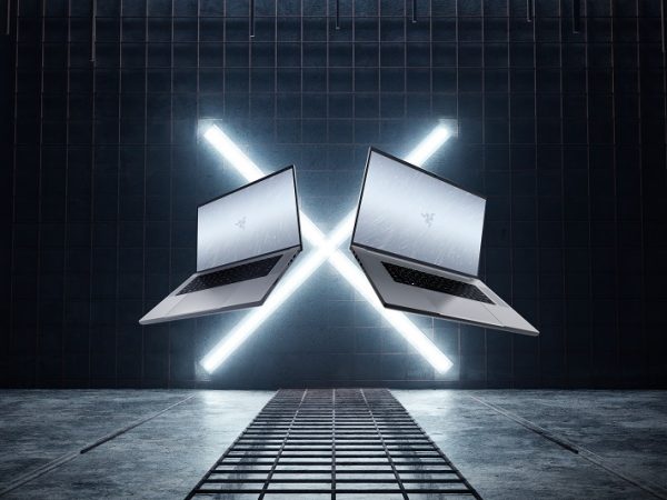 Two open laptops floating in front of a lit X