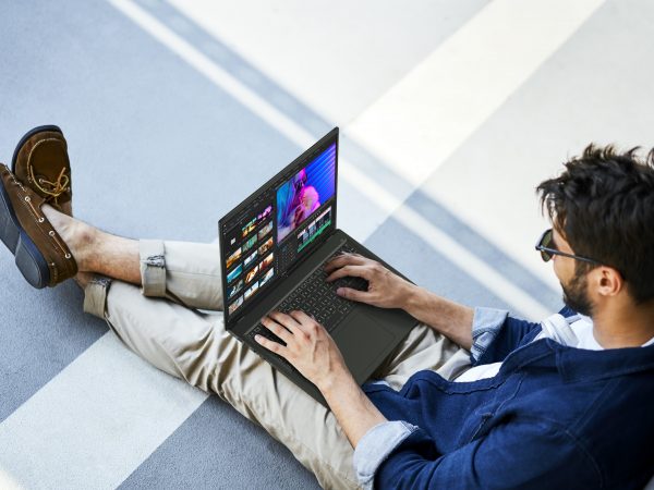 Man working on laptop with legs outstretched, as seen from above
