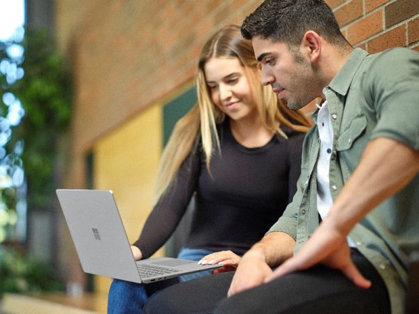 Woman and man viewing what's on a laptop computer