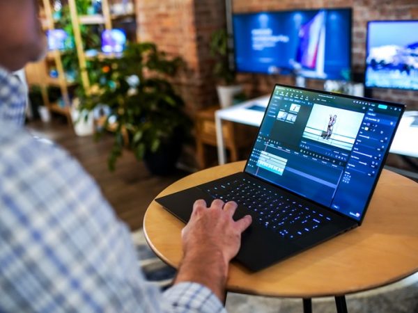 Man working on laptop, as seen from behind him
