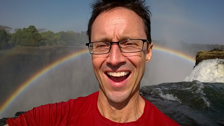 On the edge of the Falls in Devil’s Pool, the most dramatic swimming hole on earth. Livingstone Island, Zambia.
