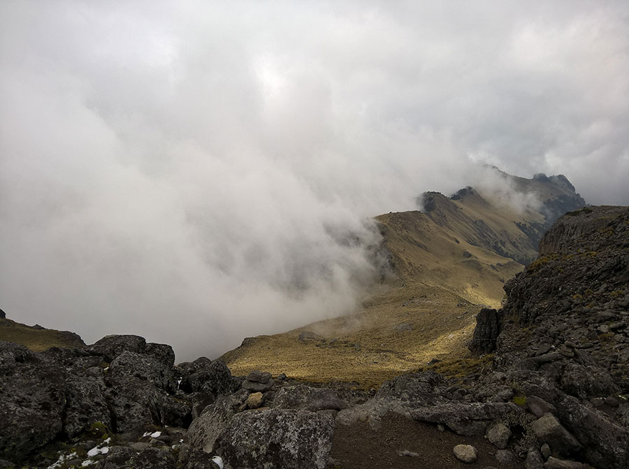 A blanket of fog rolls off a ridge, revealing a glimpse of massive Iztaccihuatl volcano, Mexico. Shot with Lumia 640 XL