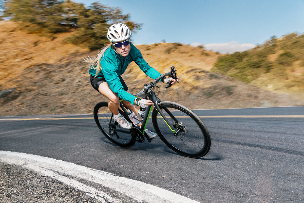 A female biking on a road.