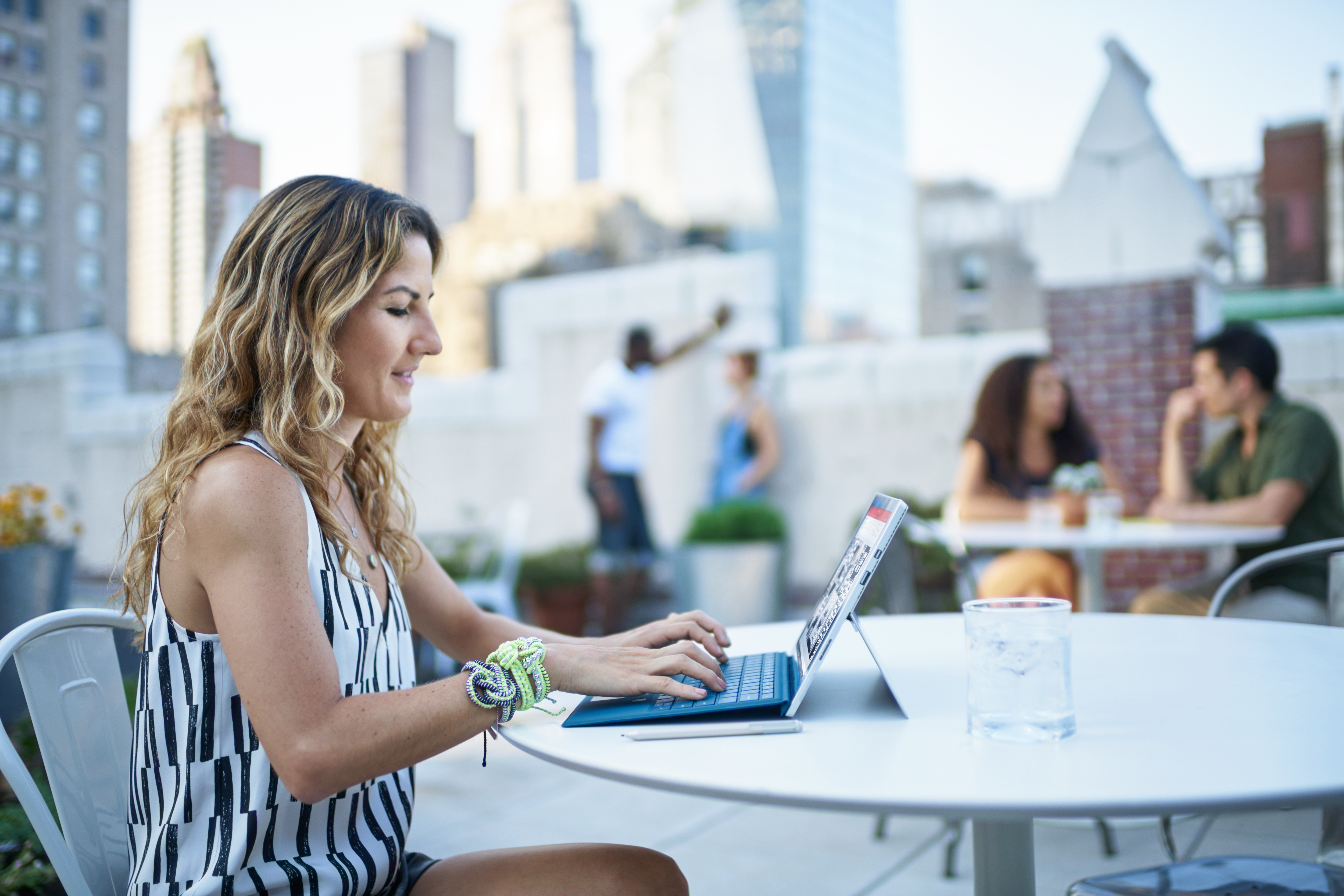 Ariela working on her Surface at an outdoor restaurant.
