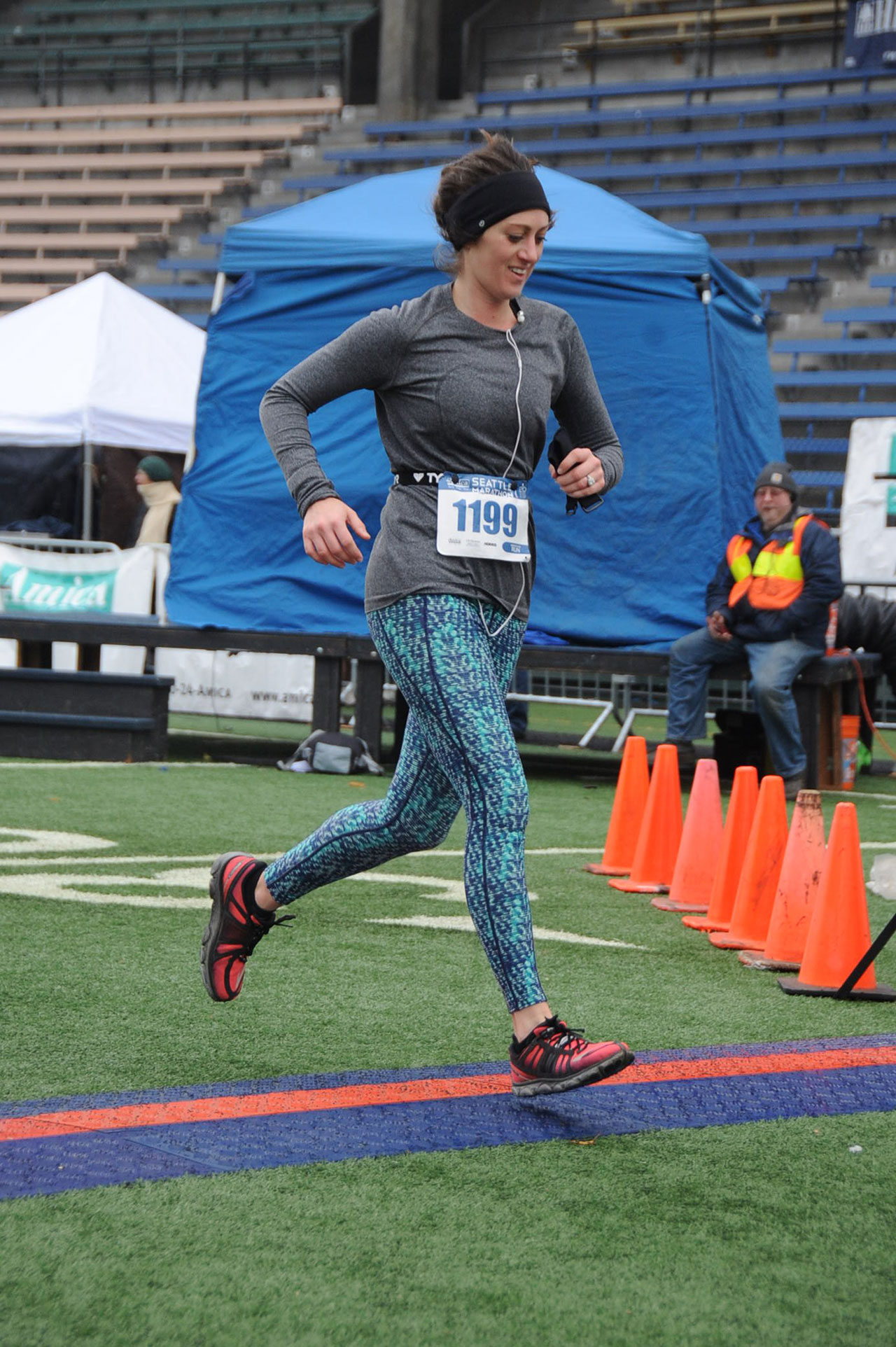 Ultramarathonist and Microsoft employee Lindsey Matese stepping across the finish line at Seattle Marathon.