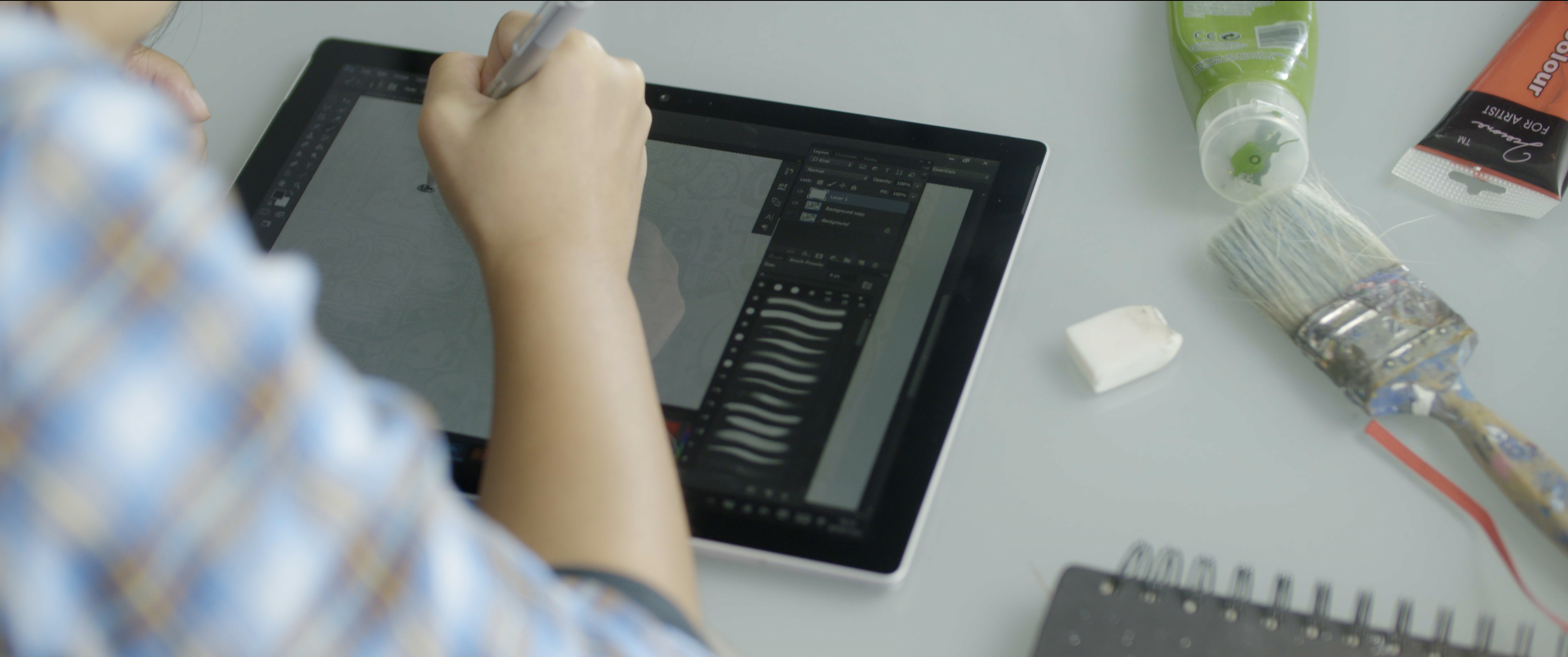 A close up of Bao working on her mural art on her Surface.