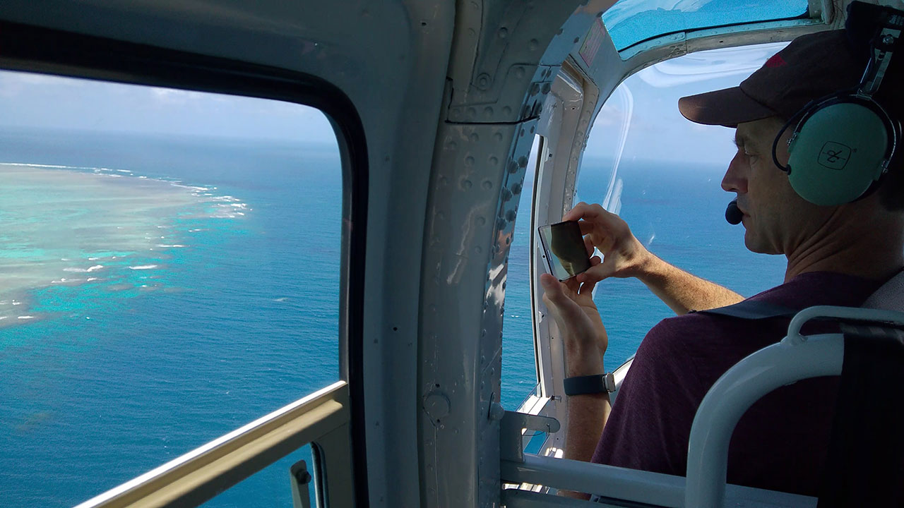 National Geographic photographer Stephen Alvarez taking an aerial picture of the Great Barrier Reef.