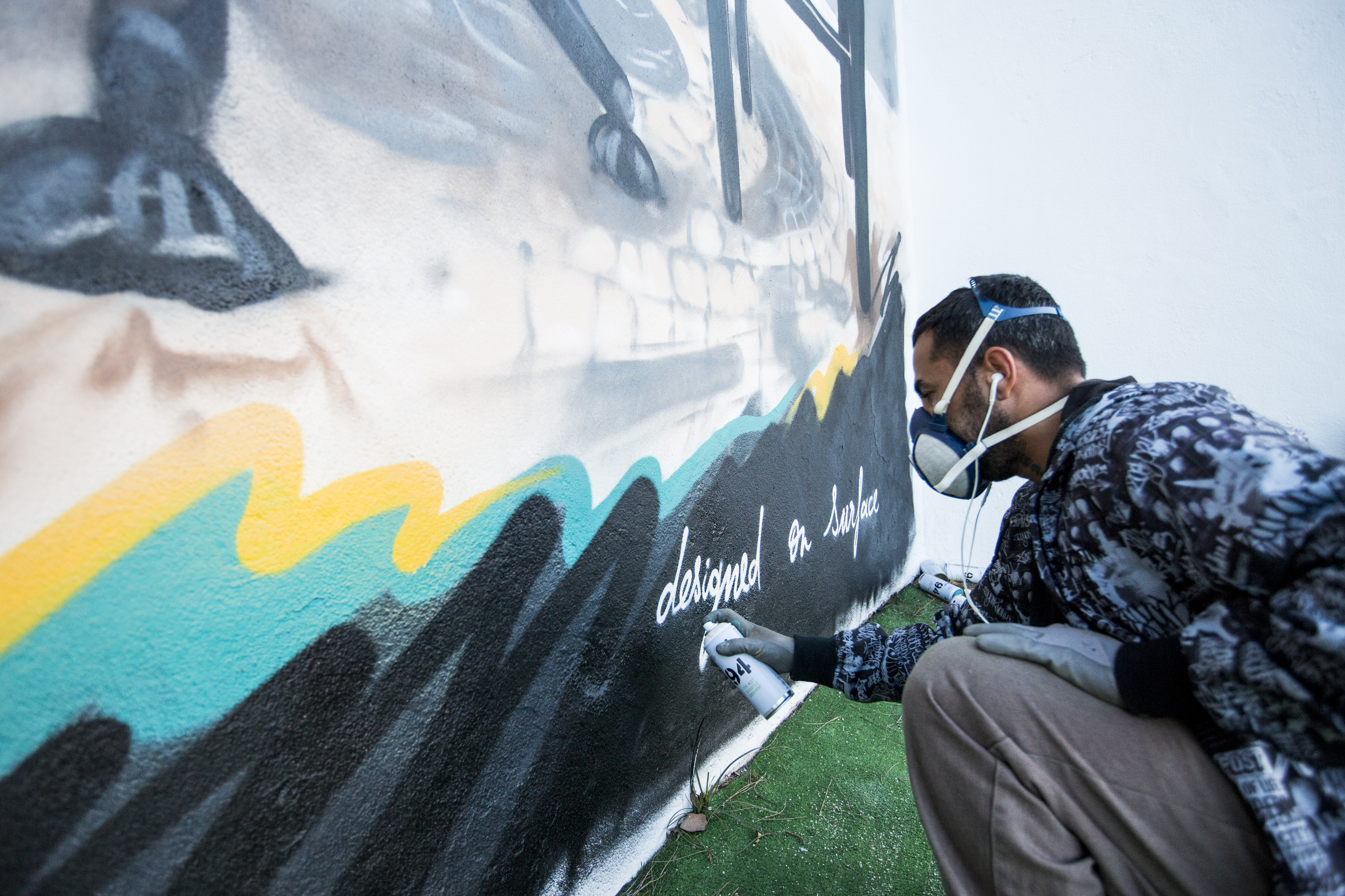 Artist Sergio Odeith painting his mural.