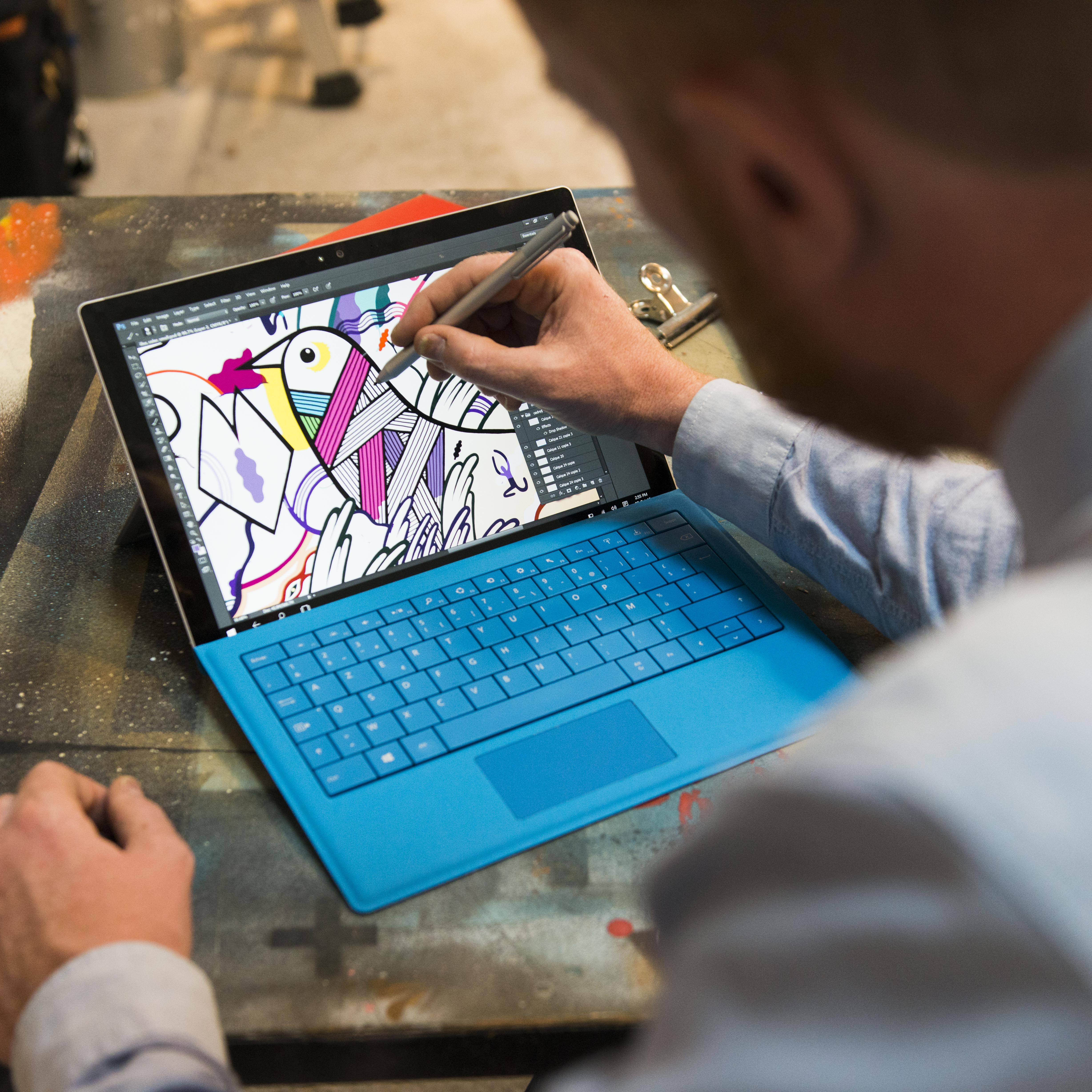 Pablito Zago desinging his mural using Surface.