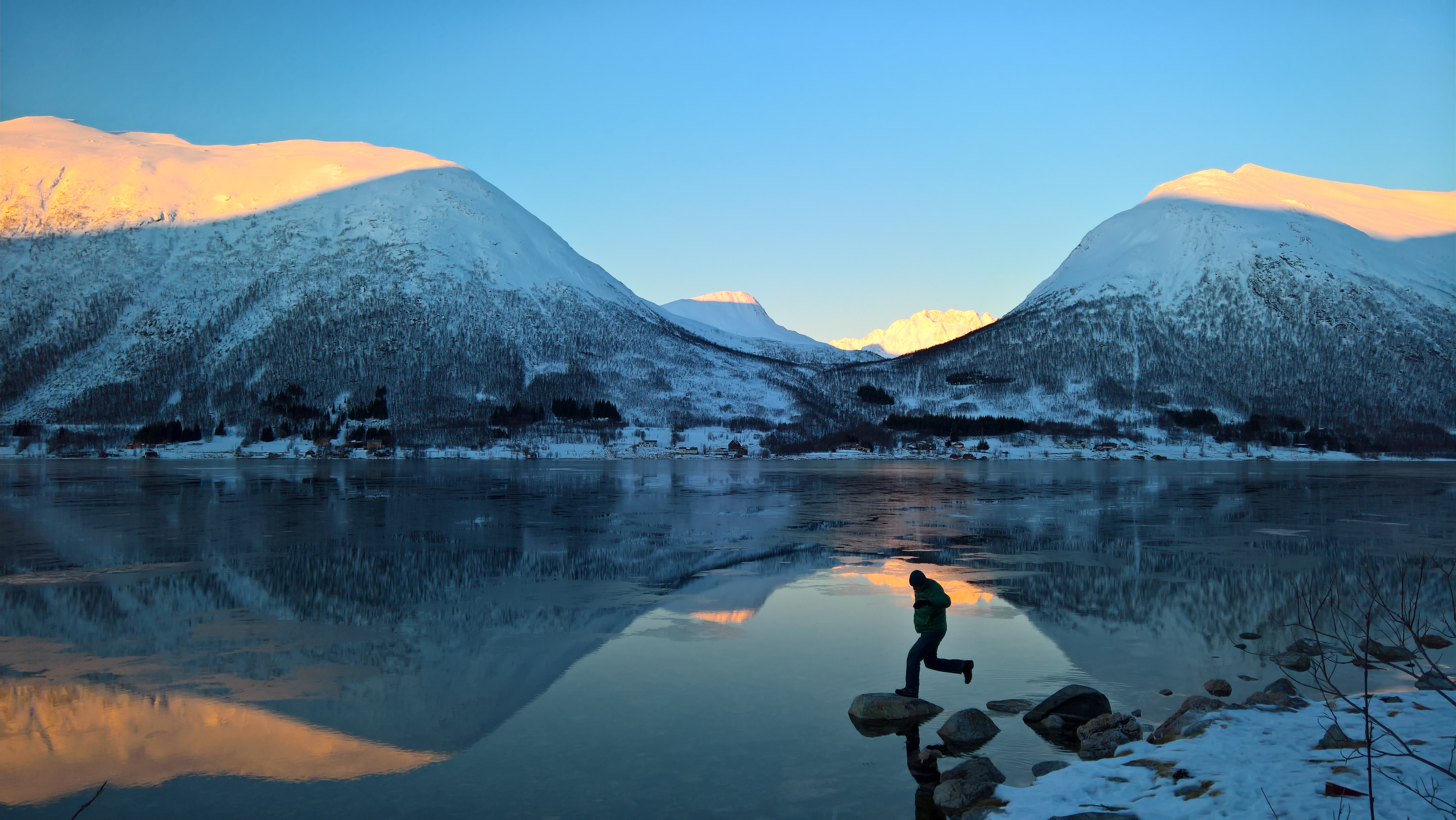 Shadow, light, and water create dramatic reflections and silhouettes along the Synnov Nordvegen Road near Tromso, Norway. Shot with Lumia 950, by Stephen Alvarez.