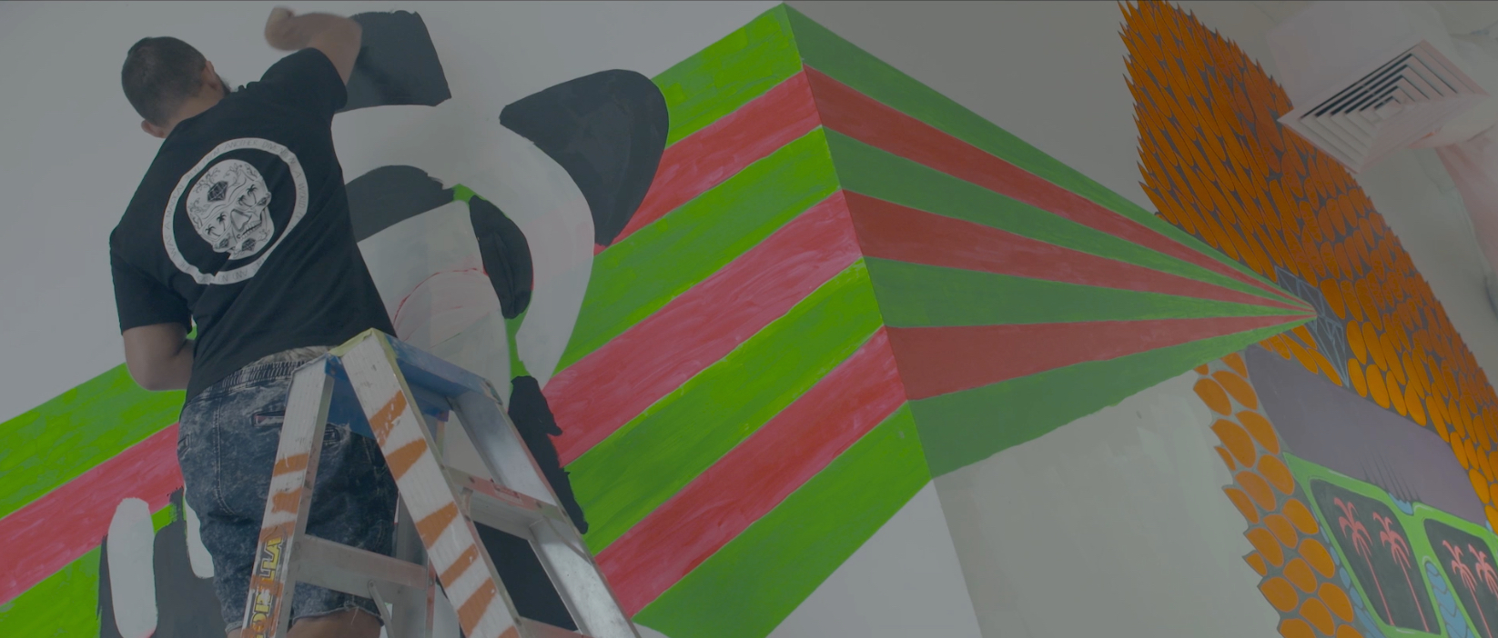 Mulga painting his indoor mural.