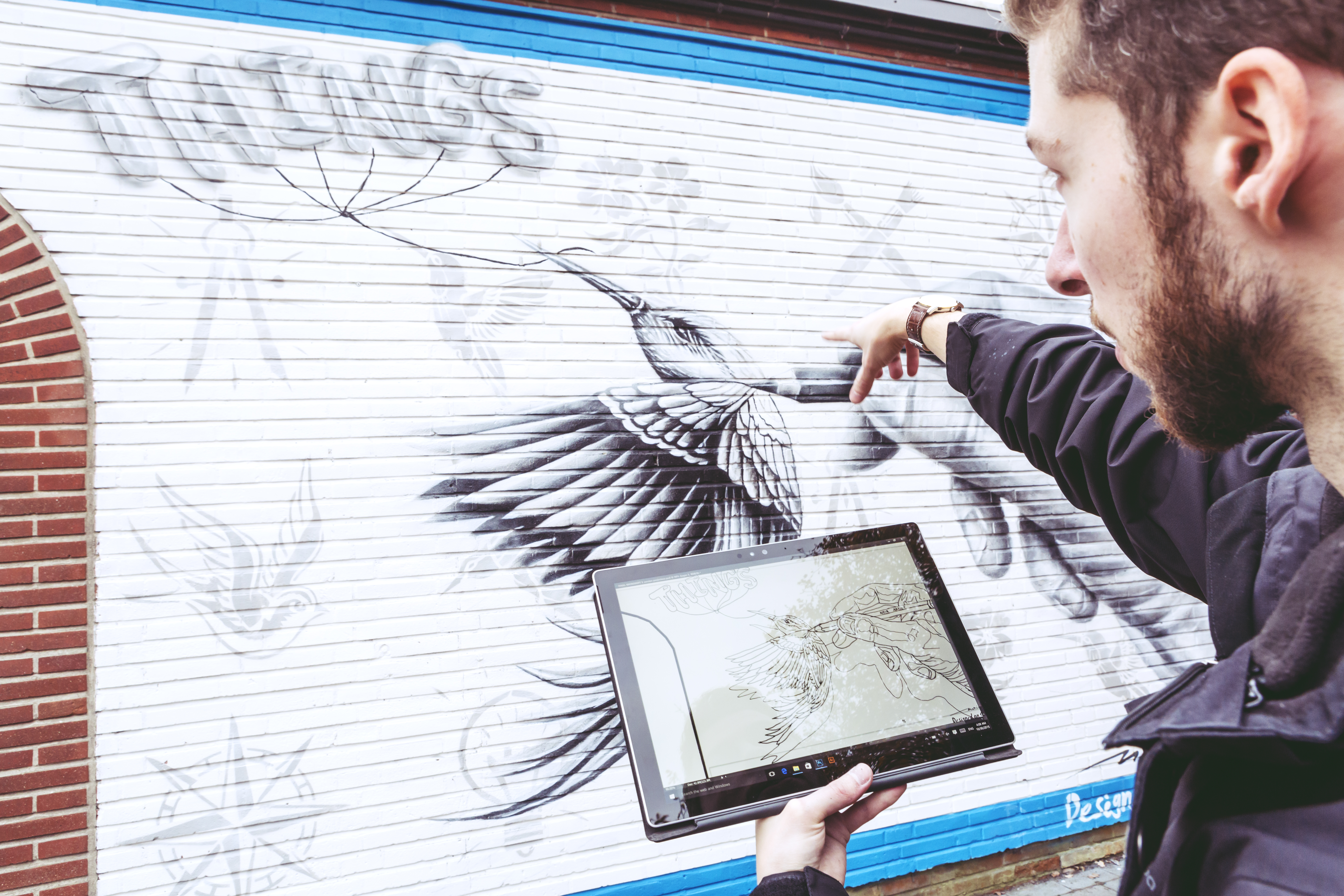 Noir, muralist from Belgium, working on his mural using Surface.
