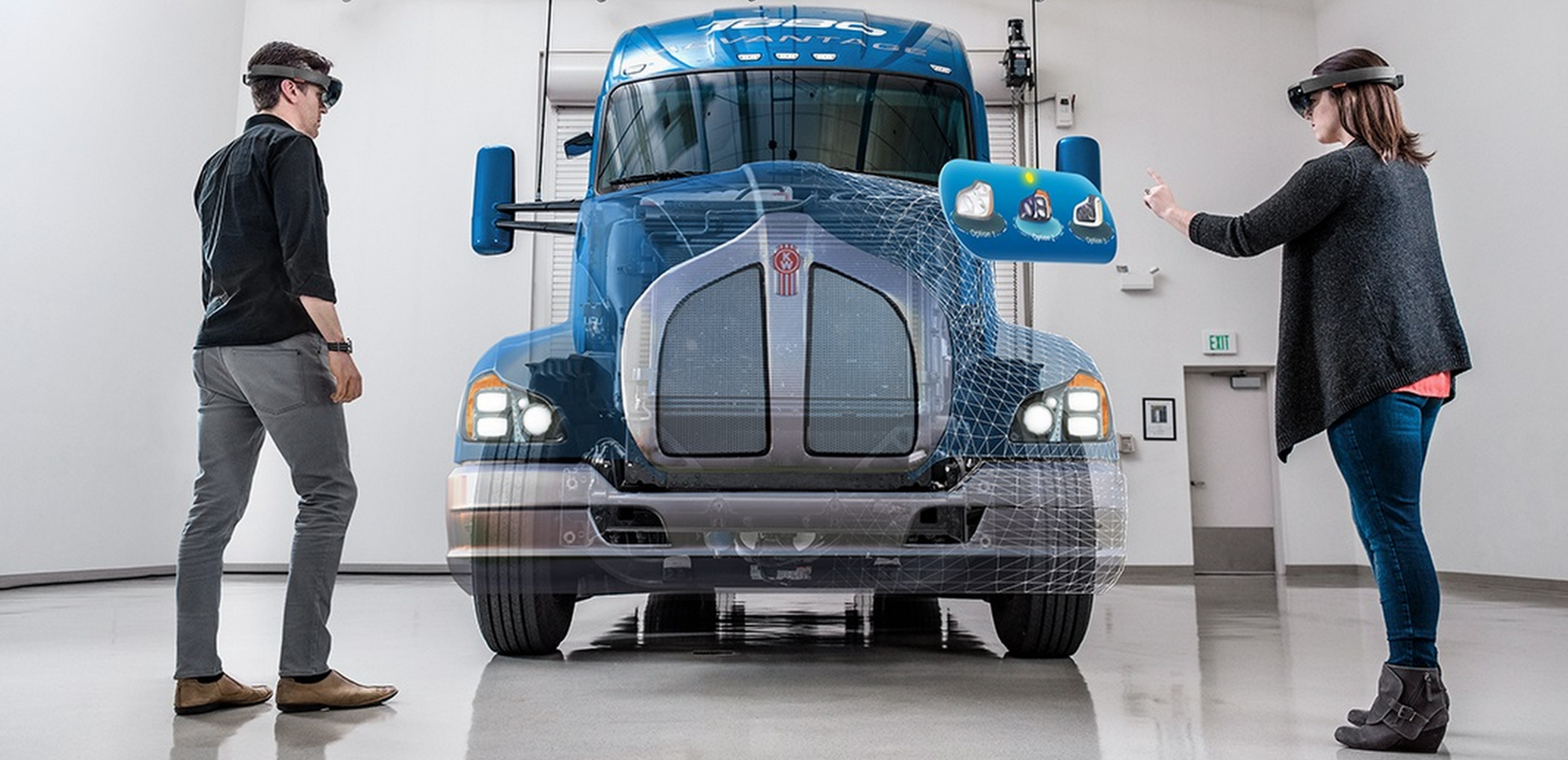 Two people wearing HoloLens standing in front of a truck