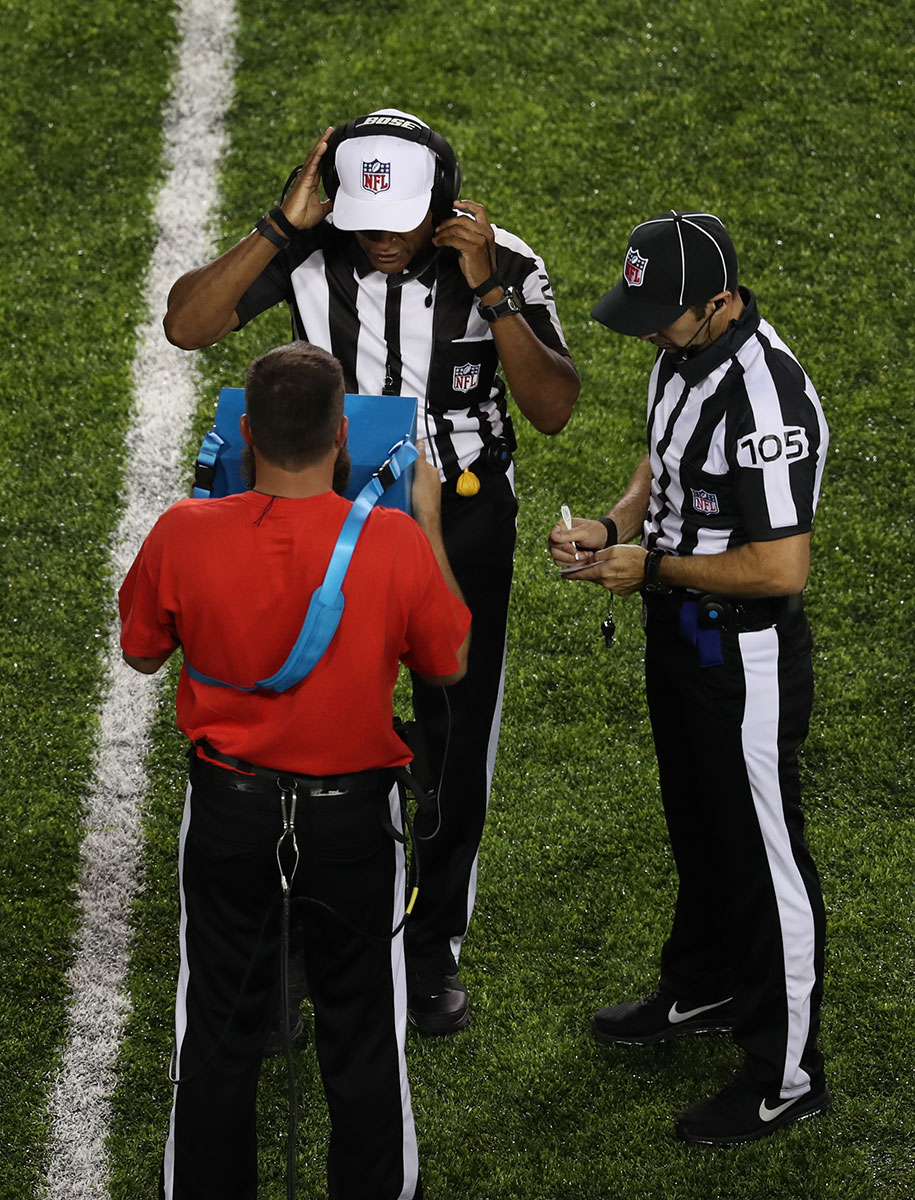 Referees reviewing a play on the new Instant Replay system featuring Surface Pro 4.