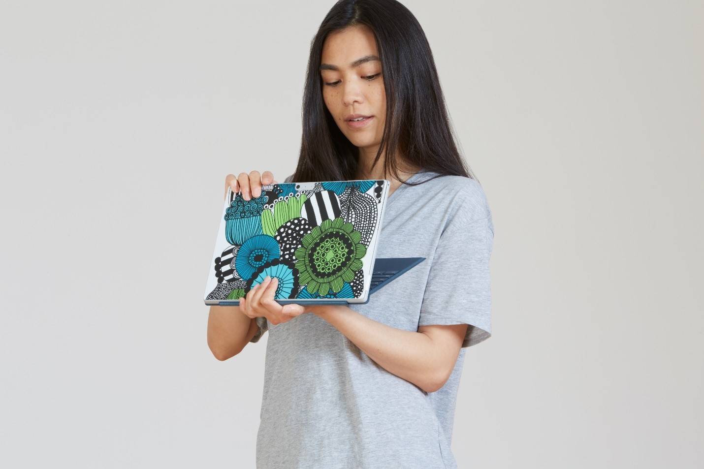 Woman holding Surface Pro.