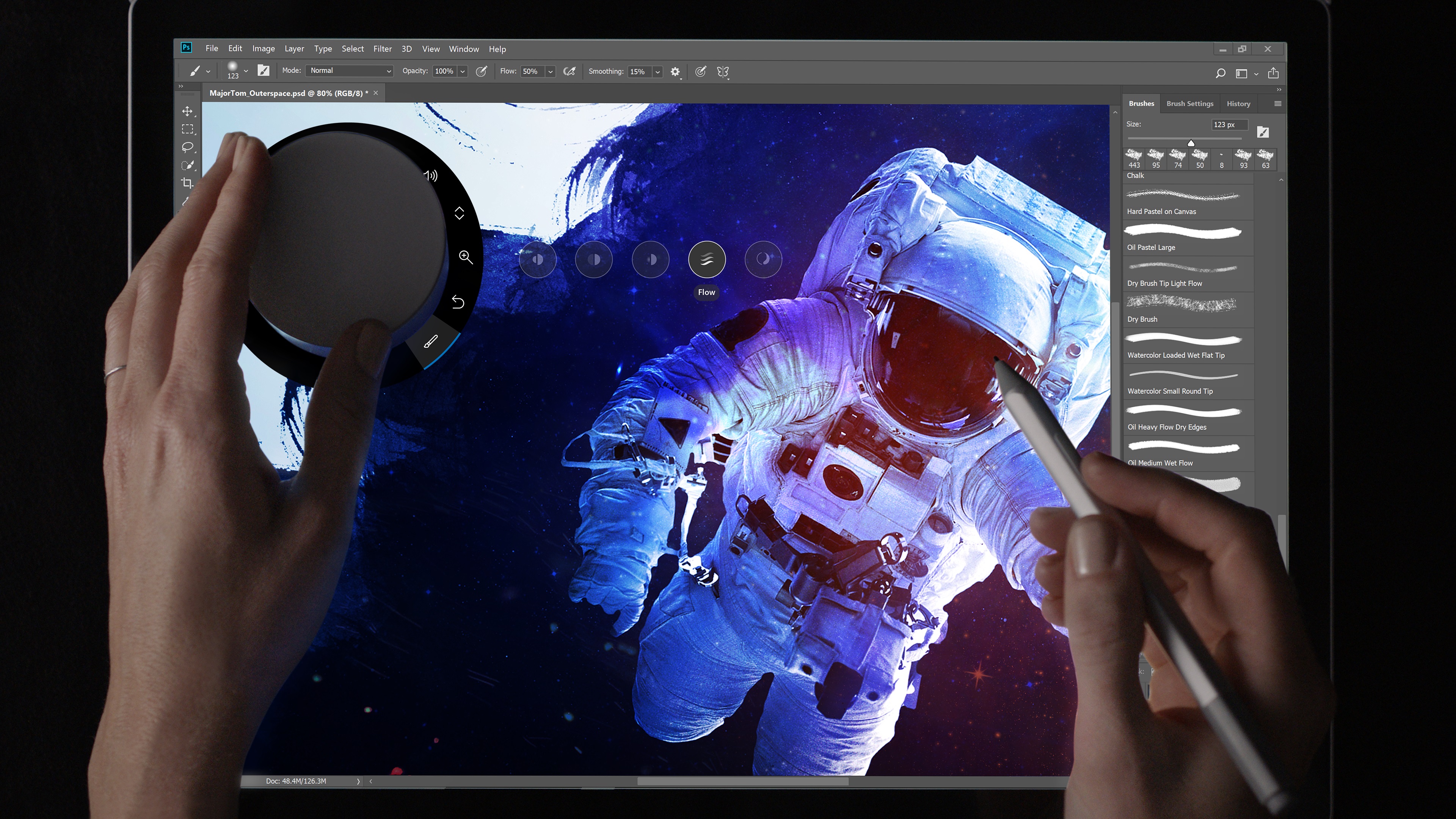 New Photoshop CC features for Surface Dial shown with person's hands holding a Surface Dial and Surface Pen.