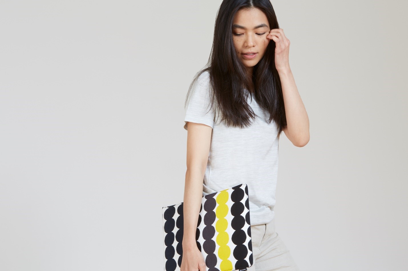 Woman holding Surface Pro in a Marimekko printed sleeve.