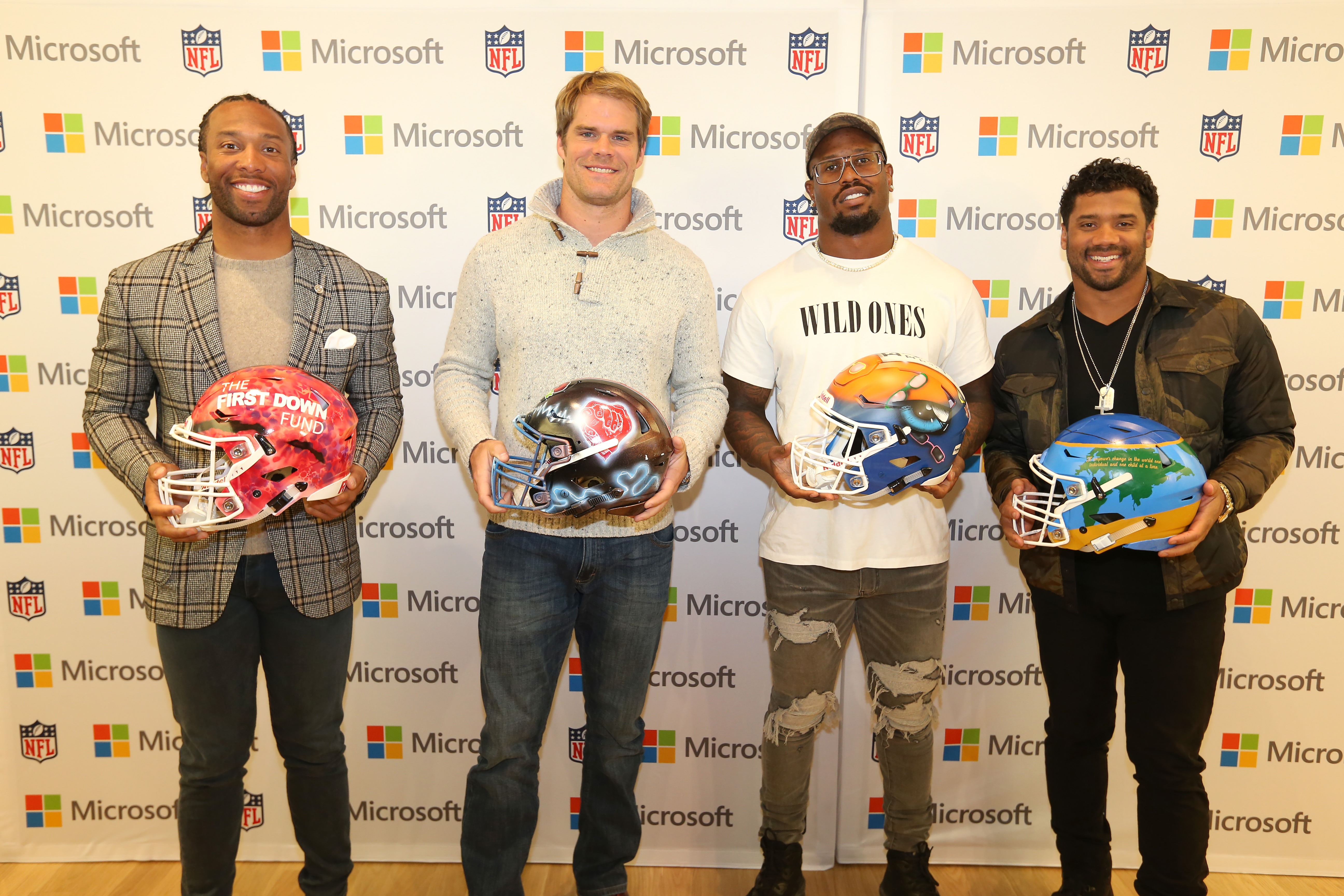 NFL players Larry Fitzgerald, Greg Olsen, Von Miller, and Russell Wilson pose with their custom designed helmets as part of Microsoft's Create Change program at the Microsoft Store at Mall of America