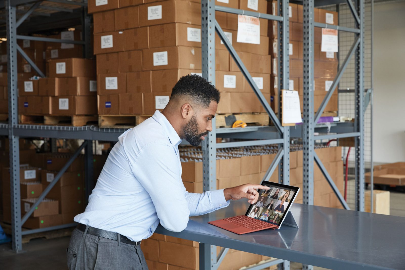 Man in a warehouse using a Surface device