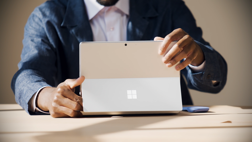 A person engaging the kickstand on a Surface device.