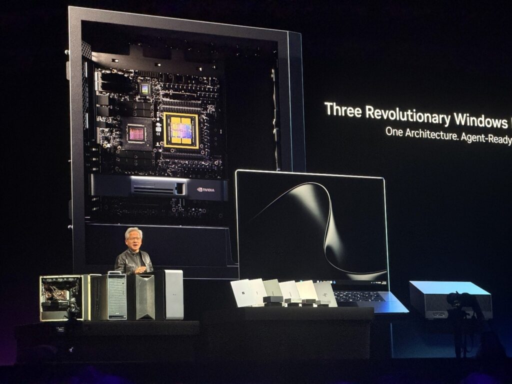 Photo of a man on a stage in front of a blown up photo of a chip