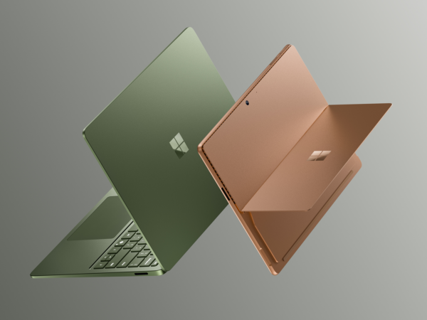 Two Surface Laptops floating and open back to front
