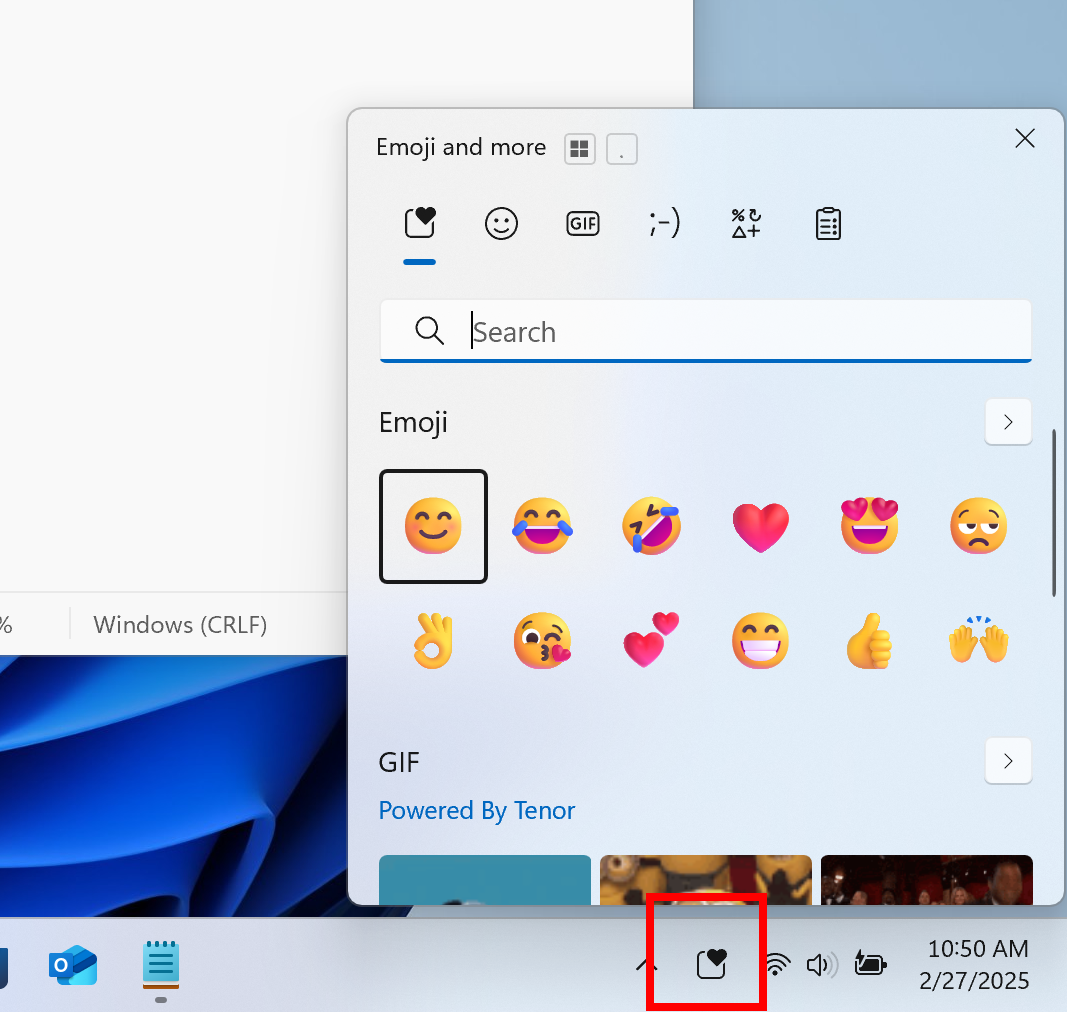 The new system tray icon for the emoji and more panel highlighted with a red box.