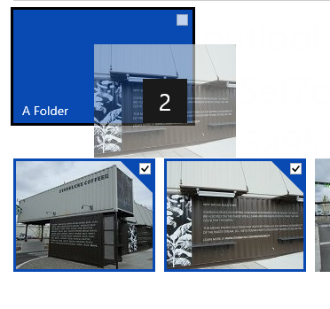 Two photos selected with a check box, being dragged to a folder